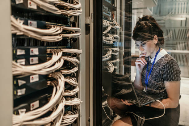 server room Female IT Engineer Working in Server Room supercomputer stock pictures, royalty-free photos & images