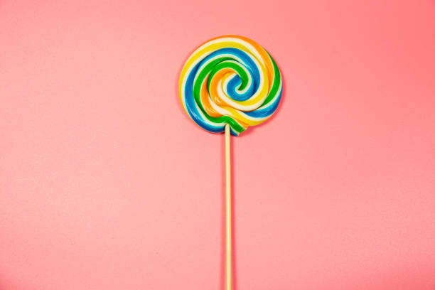 istock Colorful lollipop colored round candy. Top view blue pastel background 1145686357