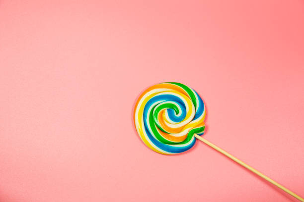istock Colorful lollipop colored round candy. Top view blue pastel background 1145686369