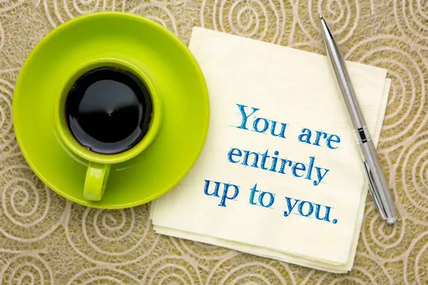 You are entirely up to you - inspirational handwriting on a napkin with a cup of coffee