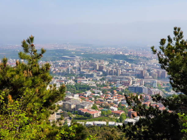 istock City landscape with green trees in foreground on a sunny day 1145686741