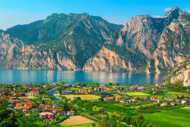Photo of Fantastic Torbole cityscape with plantations and lake Garda, Italy, Europe