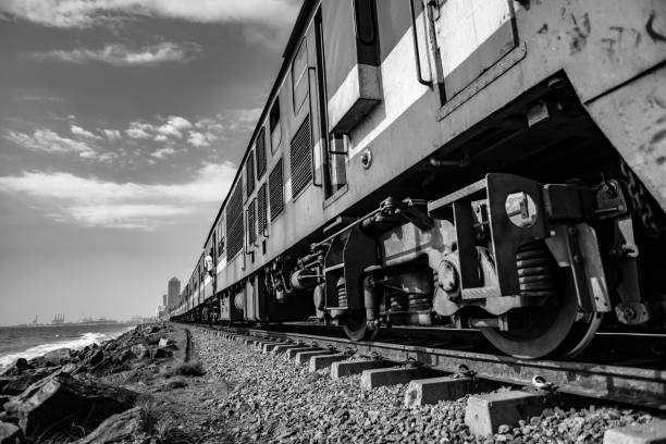 Train travel in Colombo, Sri Lanka Low angle view of a passenger train traveling along the coast of Colombo, Sri Lanka. colombo train stock pictures, royalty-free photos & images
