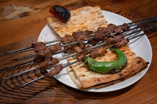Turkish meat sish kebab, sis kebap served on wood, cutting board