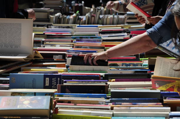 Milan, Italy - April 28, 2019: Book shop in a flea market. People searching for a book.