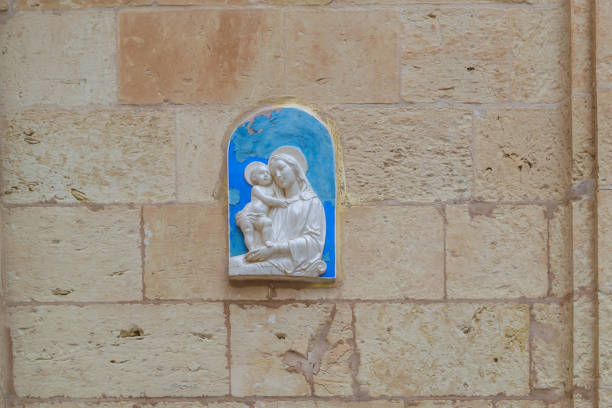 Detail of the Virgin Mary in terracotta sculpture with Jesus child - image with copy space
