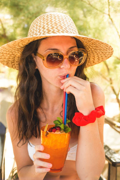 istock Woman holding a fruit cocktail on a tropical beach 1145689062
