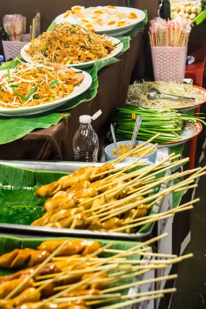 Pad Thai noodles and Sausage on banana leaf ready to eat on in street market Thailand ฺBangkok