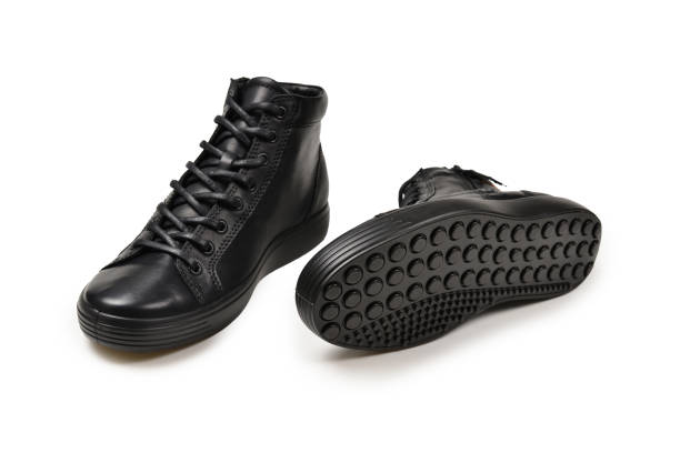 istock Men's black leather shoes and a black camera on a isolated on white background. Copy space. 1145691401