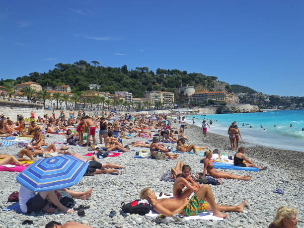 Nice, France - August 18 2010: People enjoying the beach in Nice on a sunny summer day.
