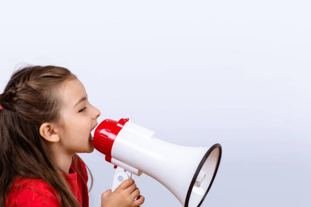 istock Little girl screaming on a megaphone. 1145691652