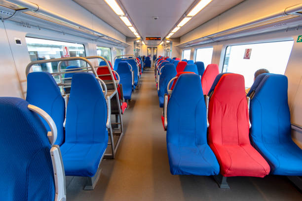 istock Empty interior of a train carriage with the red and blue seats 1145692917