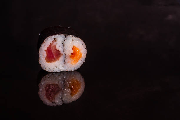 istock Fresh and tasty sushi on dark background 1145694304
