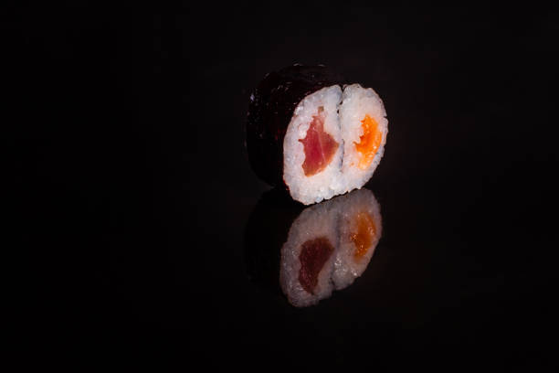 istock Fresh and tasty sushi on dark background 1145694330