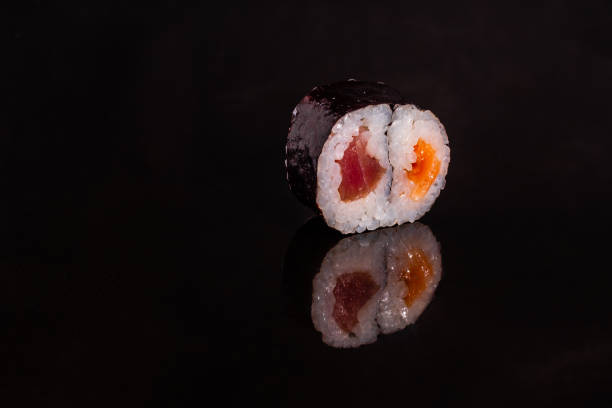 istock Fresh and tasty sushi on dark background 1145694339
