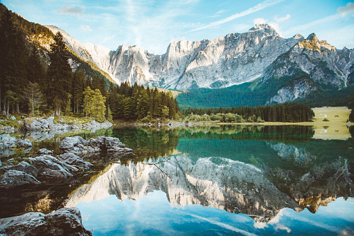 Beautiful morning view of famous Superior Fusine Lake with Mount Mangart in the background at sunrise, Tarvisio, Udine province, Friuli Venezia Giulia, Italy