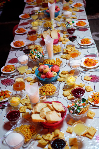 Top view of traditional Kyrgyz appetizer before diner in mountains yurt.  There are fruits, bread and jam, candy, serial, homemade chips and cheese. It is a place where tourist eat on three days horseback riding from near Kochkor to to Lake Song-Kul in Kyrgyzstan.