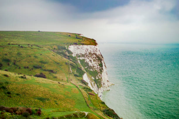 istock Dover cliffs of white lime and blue sky with lots of clouds 1145699704