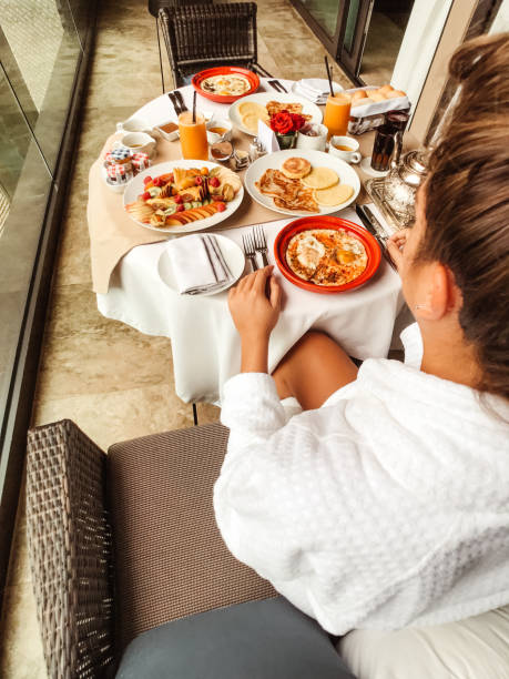 istock woman at the table for the buffet breakfast with fruit 1145700140