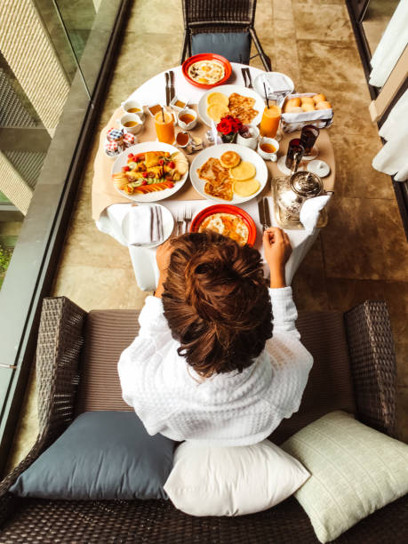 istock woman at the table for the buffet breakfast with fruit 1145700182