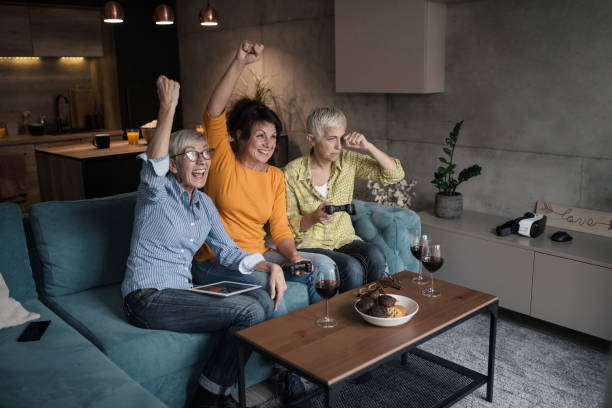 istock senior women having great time together, playing video game 1145700863