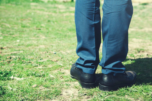 istock man feet on green grass 1145702144