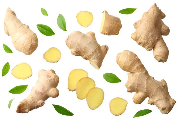 Photo of sliced ginger with leaves isolated on white background top view