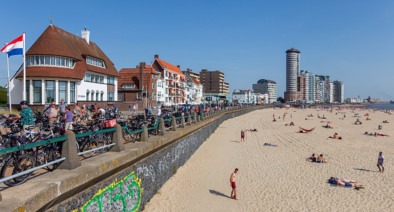 Vllissingen, The Netherlands. April 22nd 2019: Boardwalk and skyline with beach of Vlissingen. Many people enjoy the unusually warm spring day in 2019.
