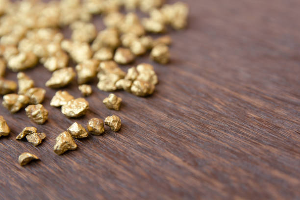istock mound of gold nugget on dark wood background 1145706268