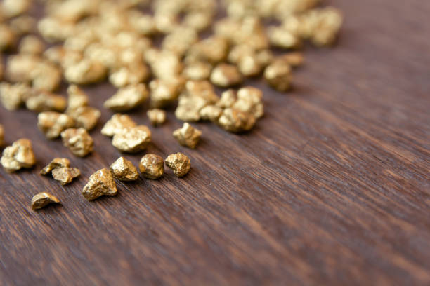 istock mound of gold nugget on dark wood background 1145706343