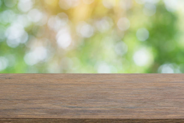 istock Empty dark wood table top and blur nature background with copy space for display or montage your products 1145706379