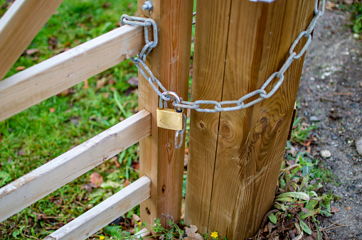 Lock and chain at one wooden gate