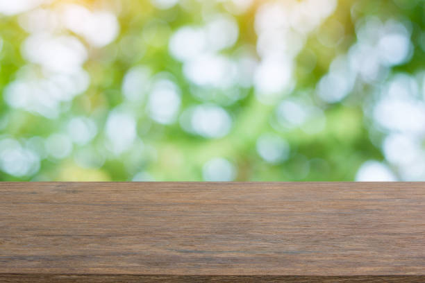 istock Empty dark wood table top and blur nature background with copy space for display or montage your products 1145706775