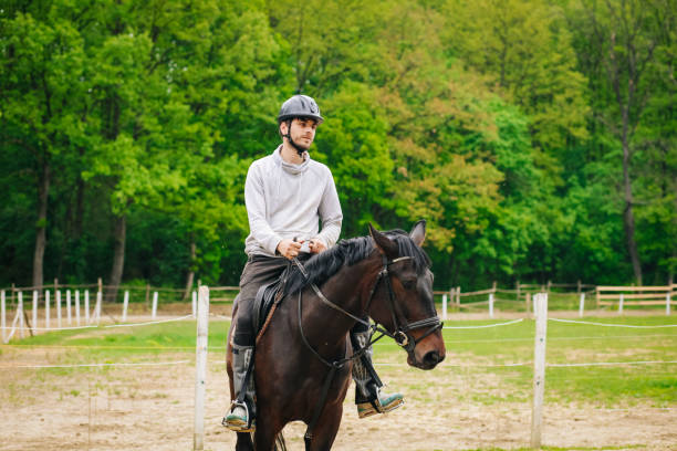 istock Young man is enjoying horseback riding in nature 1145708853