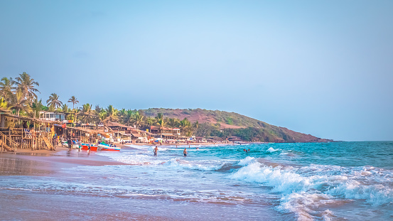 Sinquerim Beach, Sinquerium, Kandoli, Goa, India. The palm trees grow along the beautiful Indian ocean beach.