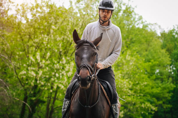 istock Young man is enjoying horseback riding in nature 1145709879