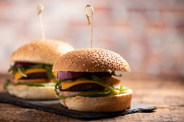 istock hamburger with lettuce, cheddar cheese, onions, tomato 1145717129