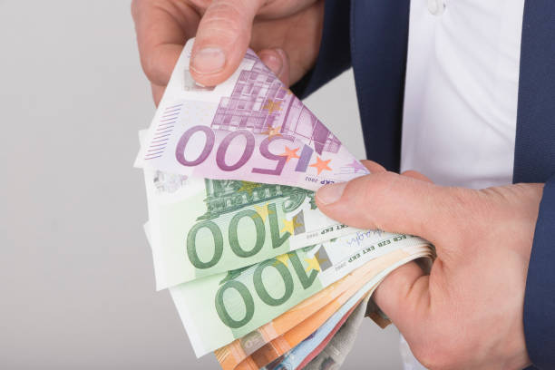 istock High angle view of businessman counting money 1145717200