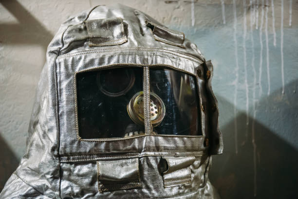 istock Dummy in gas mask and vintage silver fire suit 1145717242