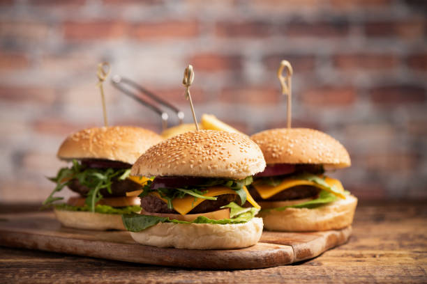 istock hamburger with lettuce, cheddar cheese, onions, tomato 1145717256