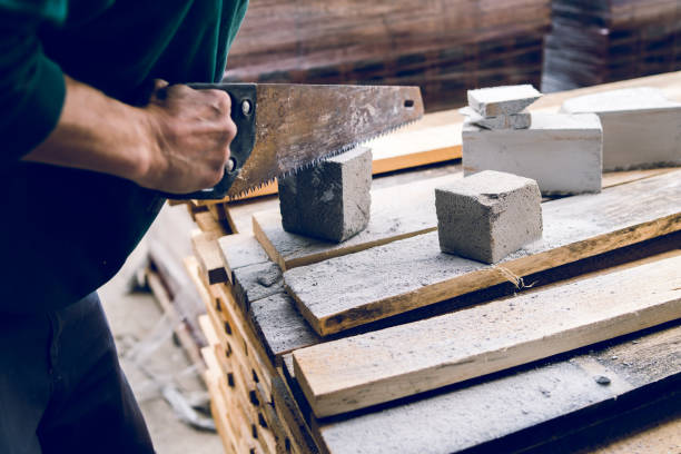istock Close up on the construction worker using the hand saw to manually cut the brick insulation material concrete stone 1145717362