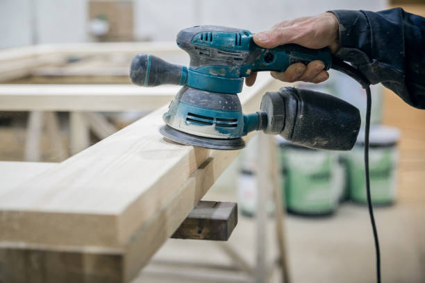 istock Worker sanding the wooden surface. In the hand of the power tool. 1145717376