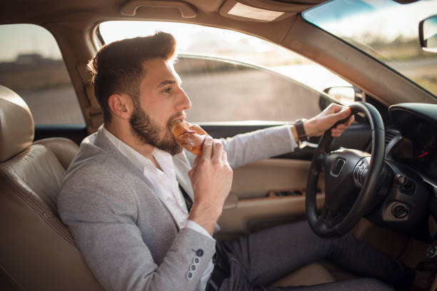istock business man having breakfast in car 1145717930