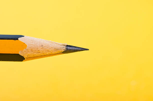 istock graphite wooden pencil on yellow background 1145718968