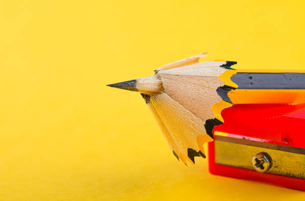 istock Back To school Concept, pencil with it shavings and sharpener over yellow background 1145718978