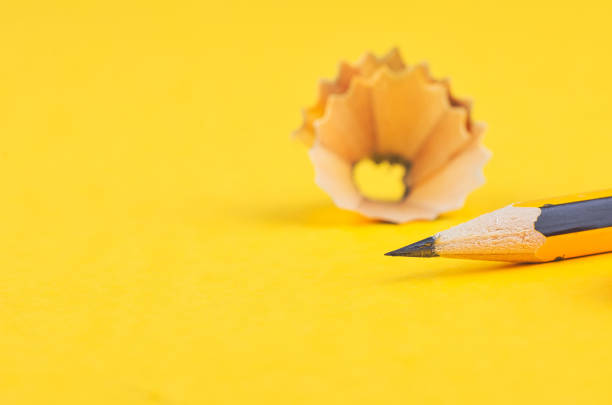 istock graphite wooden pencil on yellow background 1145718999