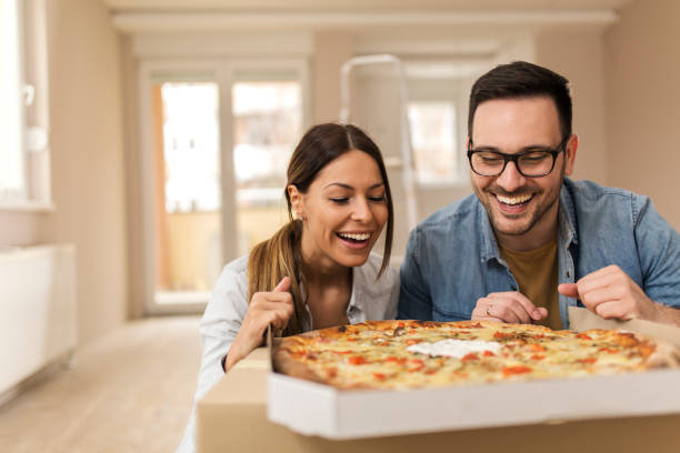 istock Beautiful couple eating pizza. 1145720517