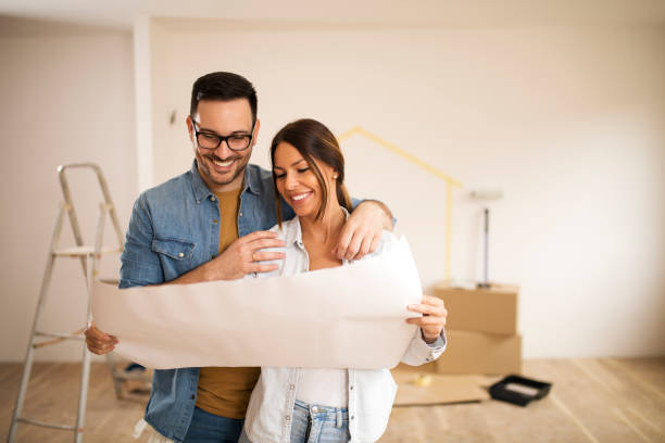 Young couple looking at blueprint.