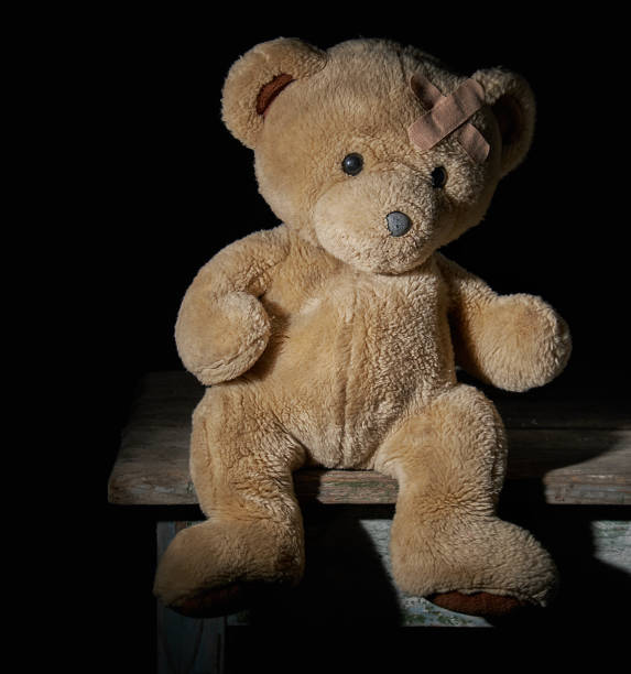 istock aold brown teddy bear is sitting on a wooden surface 1145721819