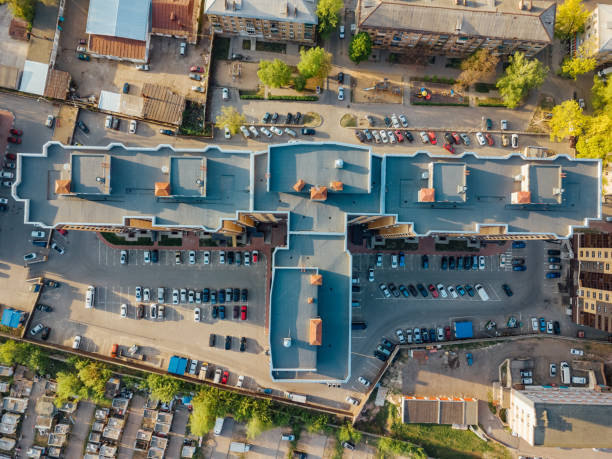 Modern residential building with parking lot, top view